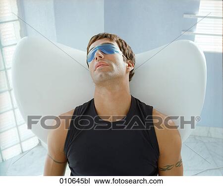man relaxing with a gelmask over his eyes View Large Photo Image Stock Image - man relaxing with a gelmask over his eyes. Fotosearch