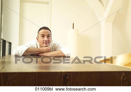 Man resting on wooden table looking up View Large Photo Image Stock Image - Man resting on wooden table looking up. Fotosearch