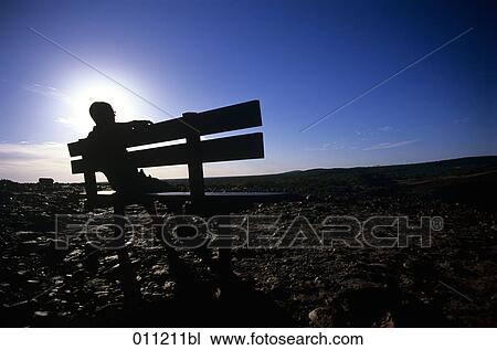 man sitting on bench View Large Photo Image Stock Image - man sitting on bench . Fotosearch