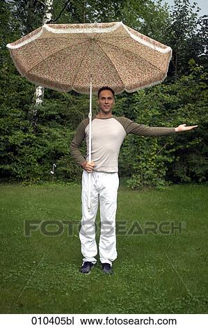 man with sunshade standing in garden View Large Photo Image Stock Image - man with sunshade standing in garden. Fotosearch