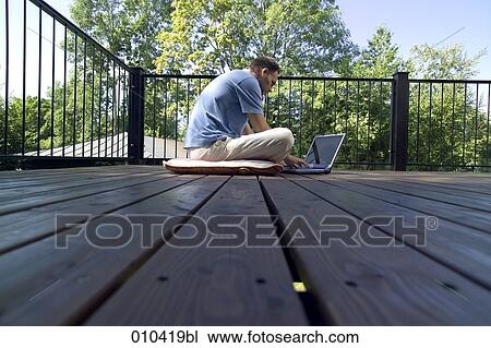 man working with laptop on his veranda View Large Photo Image Stock Image - man working with laptop on his veranda. Fotosearch