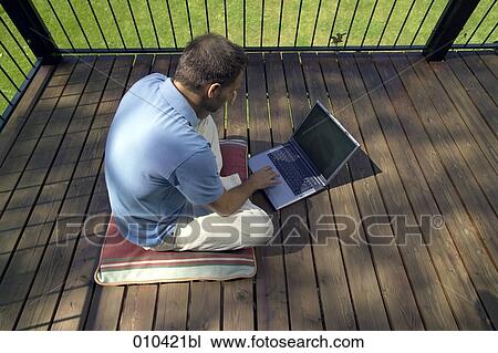 man working with laptop on his veranda View Large Photo Image Stock Image - man working with laptop on his veranda. Fotosearch