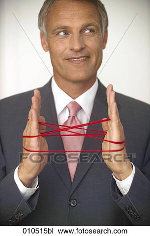 mature businessman doing the cat´s cradle with a red woolen thread View Large Photo Image Stock Image - mature businessman doing the cat´s cradle with a red woolen thread. Fotosearch