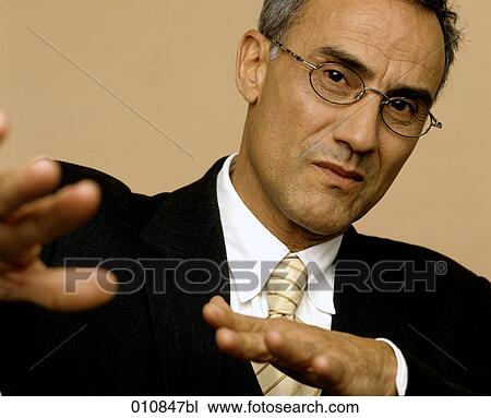 Stock Image - Mature businessman making an explanation. Fotosearch