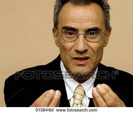 Stock Image - Mature businessman making vivid gesture. Fotosearch