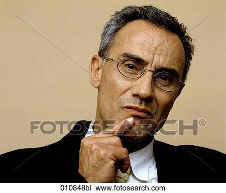 Stock Image - Mature businessman showing a thoughtful expression. Fotosearch