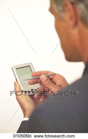 mature businessman using electronic organizer View Large Photo Image Stock Image - mature businessman using electronic organizer. Fotosearch