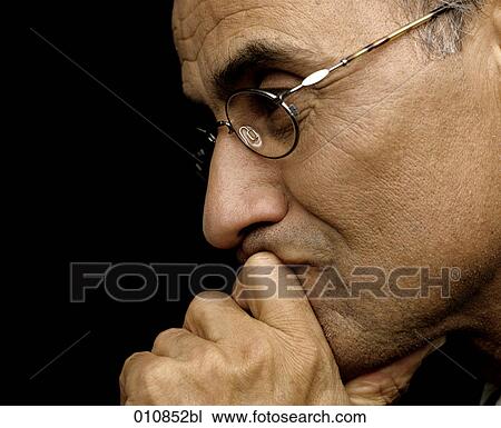 Mature man with glasses looking thoughtful View Large Photo Image Stock Image - Mature man with glasses looking thoughtful. Fotosearch