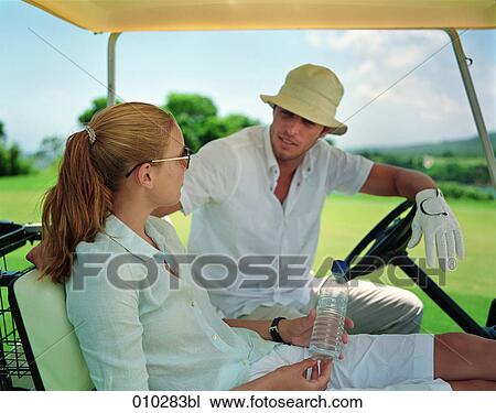 models posing in electric caddy on golf course View Large Photo Image Stock Image - models posing in electric caddy on golf course. Fotosearch