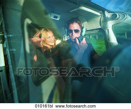 pilot in small propeller plane talking to female passengers View Large Photo Image Stock Image - pilot in small propeller plane talking to female passengers. Fotosearch