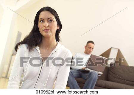 Portait of pensive looking woman while friend is working with laptop computer View Large Photo Image Stock Image - Portait of pensive looking woman while friend is working with laptop computer. Fotosearch