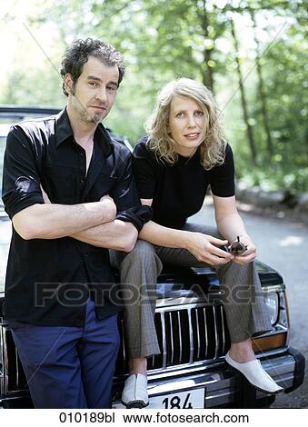 portrait of couple leaning on car View Large Photo Image Stock Image - portrait of couple leaning on car. Fotosearch