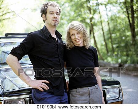 portrait of couple leaning on car View Large Photo Image Stock Image - portrait of couple leaning on car. Fotosearch