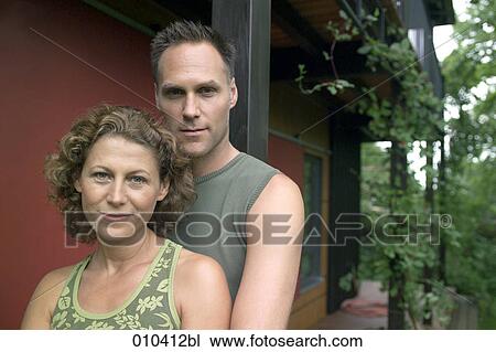 portrait of couple looking in camera View Large Photo Image Stock Image - portrait of couple looking in camera. Fotosearch