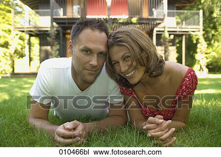 portrait of couple lying in the grass View Large Photo Image Stock Image - portrait of couple lying in the grass. Fotosearch