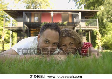 portrait of couple lying in the grass View Large Photo Image Stock Image - portrait of couple lying in the grass. Fotosearch