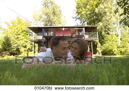 portrait of couple lying in the grass View Large Photo Image Stock Image - portrait of couple lying in the grass. Fotosearch
