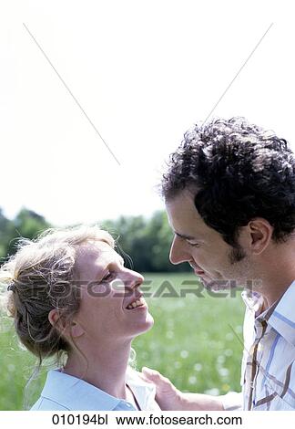 Stock Image - portrait of couple outside in the park. Fotosearch