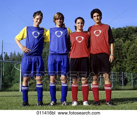 Stock Image - portrait of four teenagers in football gear. Fotosearch