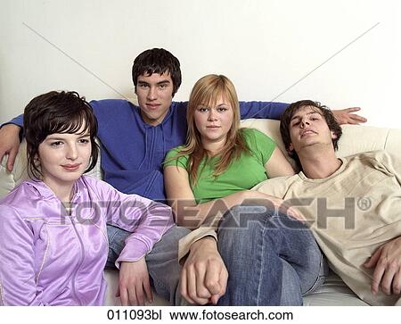 Portrait of four teenagers sitting on a couch View Large Photo Image Stock Image - Portrait of four teenagers sitting on a couch. Fotosearch