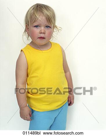 portrait of girl wearing yellow top and blue trousers View Large Photo Image Stock Image - portrait of girl wearing yellow top and blue trousers. Fotosearch
