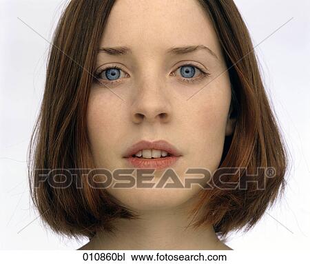 Stock Image - Portrait of insecure looking young woman. Fotosearch