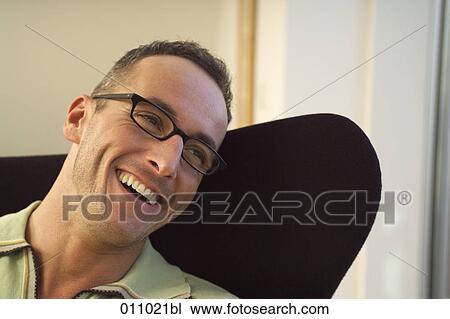 Portrait of laughing man wearing glasses View Large Photo Image Stock Image - Portrait of laughing man wearing glasses. Fotosearch