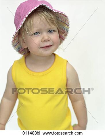 Stock Image - portrait of little girl wearing pink hat. Fotosearch