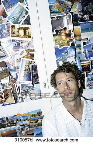 portrait of male caucasian in white shirt, background full of postcards View Large Photo Image Stock Image - portrait of male caucasian in white shirt, background full of postcards. Fotosearch
