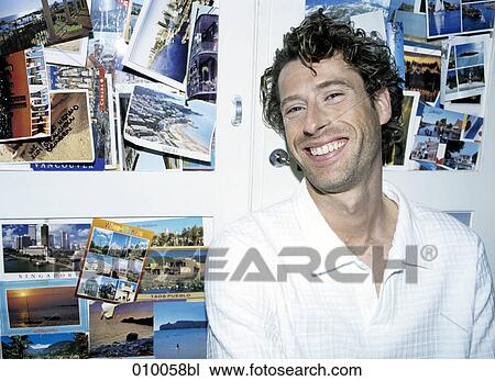 portrait of male caucasian in white shirt, background full of postcards View Large Photo Image Stock Image - portrait of male caucasian in white shirt, background full of postcards. Fotosearch