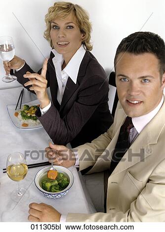 portrait of man and woman in business suits in restaurant View Large Photo Image Stock Image - portrait of man and woman in business suits in restaurant. Fotosearch