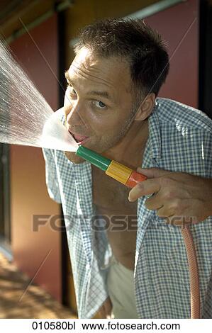 portrait of man drinking from garden hose View Large Photo Image Stock Image - portrait of man drinking from garden hose. Fotosearch