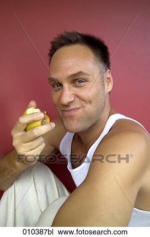 portrait of man eating an apple View Large Photo Image Stock Image - portrait of man eating an apple. Fotosearch
