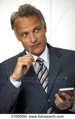 portrait of mature businessman holding electronic organizer View Large Photo Image Stock Image - portrait of mature businessman holding electronic organizer. Fotosearch