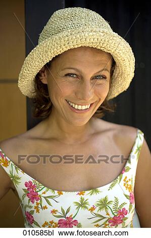 portrait of smiling woman in flowery dress wearing a straw hat View Large Photo Image Stock Image - portrait of smiling woman in flowery dress wearing a straw hat. Fotosearch