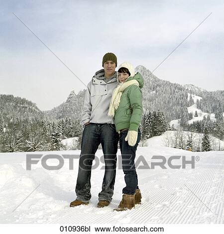 Stock Image - portrait of teenage couple in the snow. Fotosearch