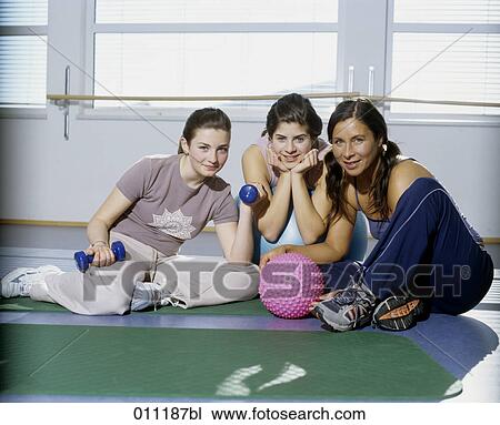 Stock Image - Portrait of three women in gym . Fotosearch