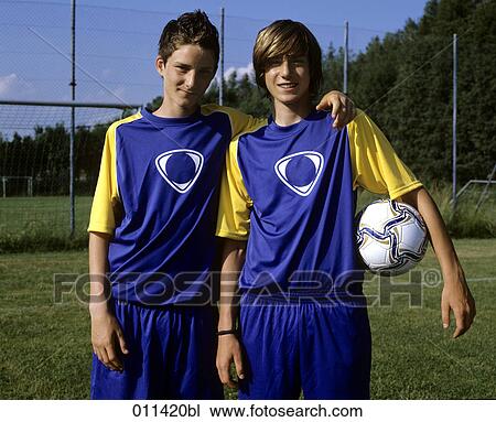 portrait of two teenage football players, one holding ball View Large Photo Image Stock Image - portrait of two teenage football players, one holding ball. Fotosearch