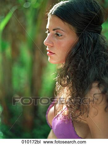 Stock Image - portrait of woman in bikini in tropical environment. Fotosearch