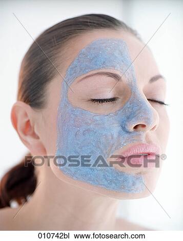 portrait of you woman with one face side covered by mud mask View Large Photo Image Stock Image - portrait of you woman with one face side covered by mud mask. Fotosearch