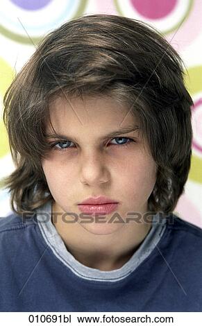 portrait of young boy looking angry View Large Photo Image Stock Image - portrait of young boy looking angry. Fotosearch