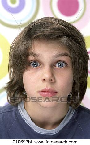 Stock Image - portrait of young boy looking astonished. Fotosearch