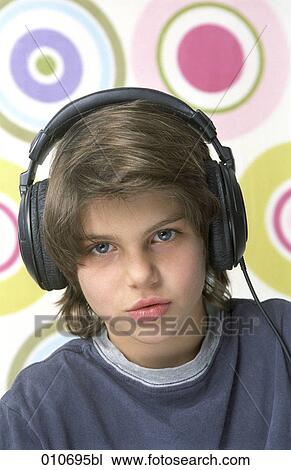 Stock Image - portrait of young boy wearing headphones. Fotosearch