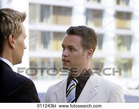 portrait of young businessman having a conversation View Large Photo Image Stock Image - portrait of young businessman having a conversation. Fotosearch
