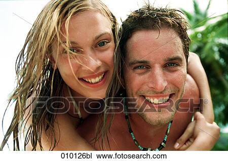 Stock Image - portrait of young couple enjoying their holiday. Fotosearch