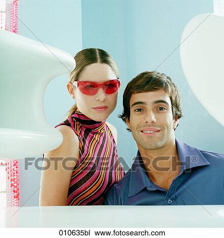 Stock Image - portrait of young couple facing camera. Fotosearch