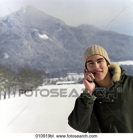 Stock Image - portrait of young male teenager talking on his cellphone. Fotosearch