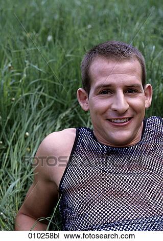 portrait of young man (20-25 years) lying in the grass View Large Photo Image Stock Image - portrait of young man (20-25 years) lying in the grass. Fotosearch