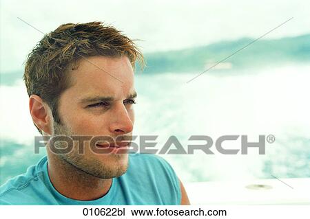 Stock Image - portrait of young man in light blue shirt. Fotosearch