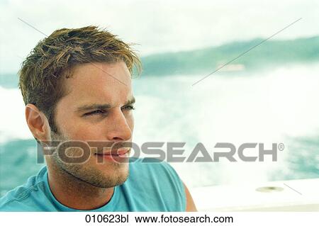 portrait of young man in light blue shirt View Large Photo Image Stock Image - portrait of young man in light blue shirt. Fotosearch